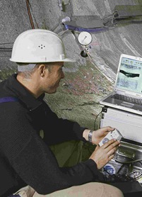 Picture with a geologist logging in a tunnel